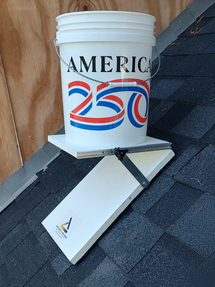 Roof Caddy holding a bucket level and secure on a shingled roof
